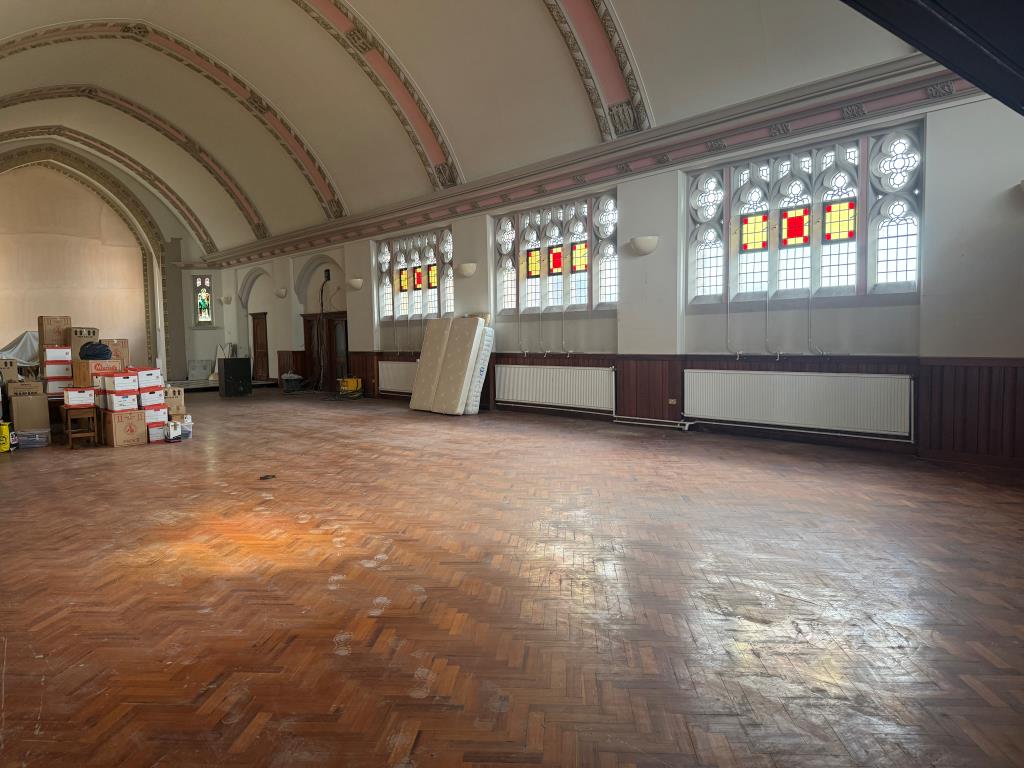 Lot: 64 - GROUND RENT INVESTMENT PLUS VACANT FIRST FLOOR FORMER CHAPEL WITH POTENTIAL - View of Church hall with stained glass windows